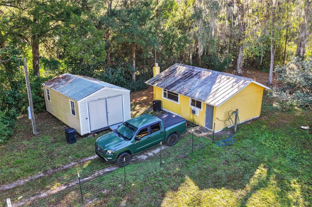 8481 Cr 636 Bushnell Bushnell, FL 33513 - Photo 4 of 25 an aerial view of a house with a yard table and chairs