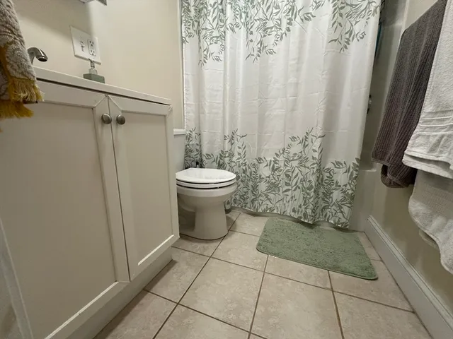 a bathroom with a toilet and shower