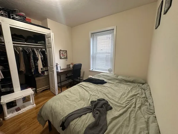 a bedroom with a bed and a flat tv screen