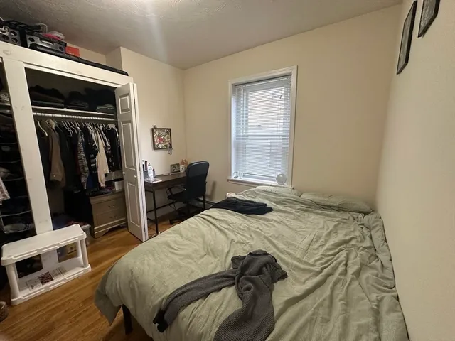 a bedroom with a bed and a flat tv screen