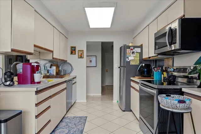 a kitchen with stainless steel appliances granite countertop a sink and cabinets