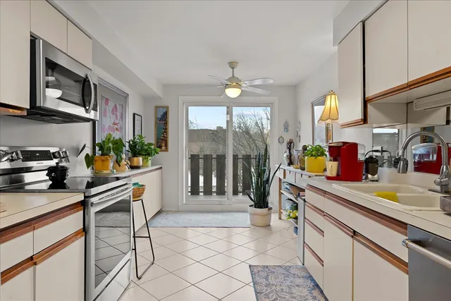 a kitchen with a sink cabinets and window