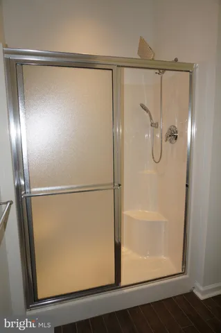 a bathroom with a glass shower door