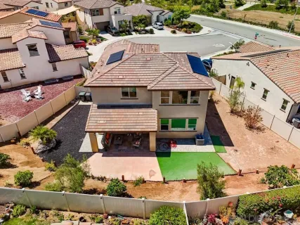 an aerial view of a house with a yard