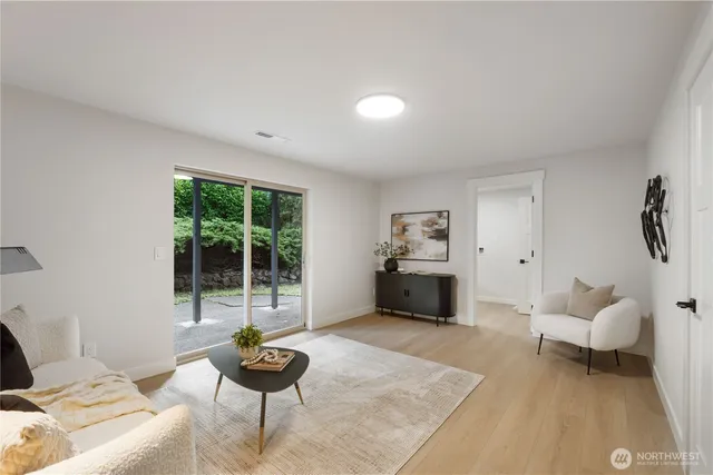 a living room with furniture and a potted plant