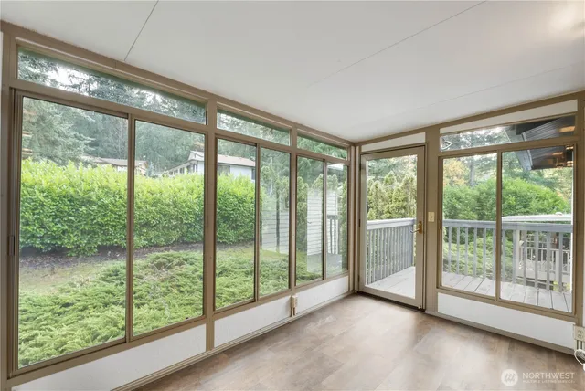 a view of a room with large windows and pool