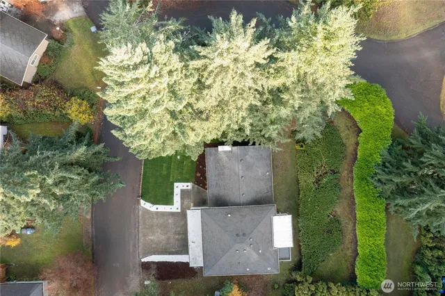an aerial view of a house with a yard