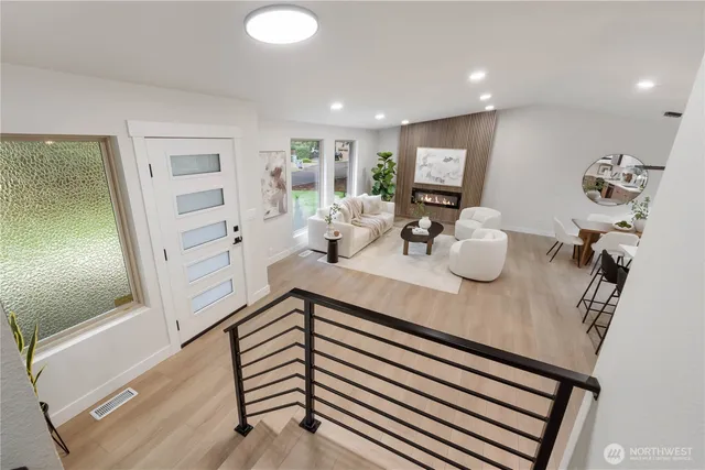 a kitchen view with wooden floor and windows