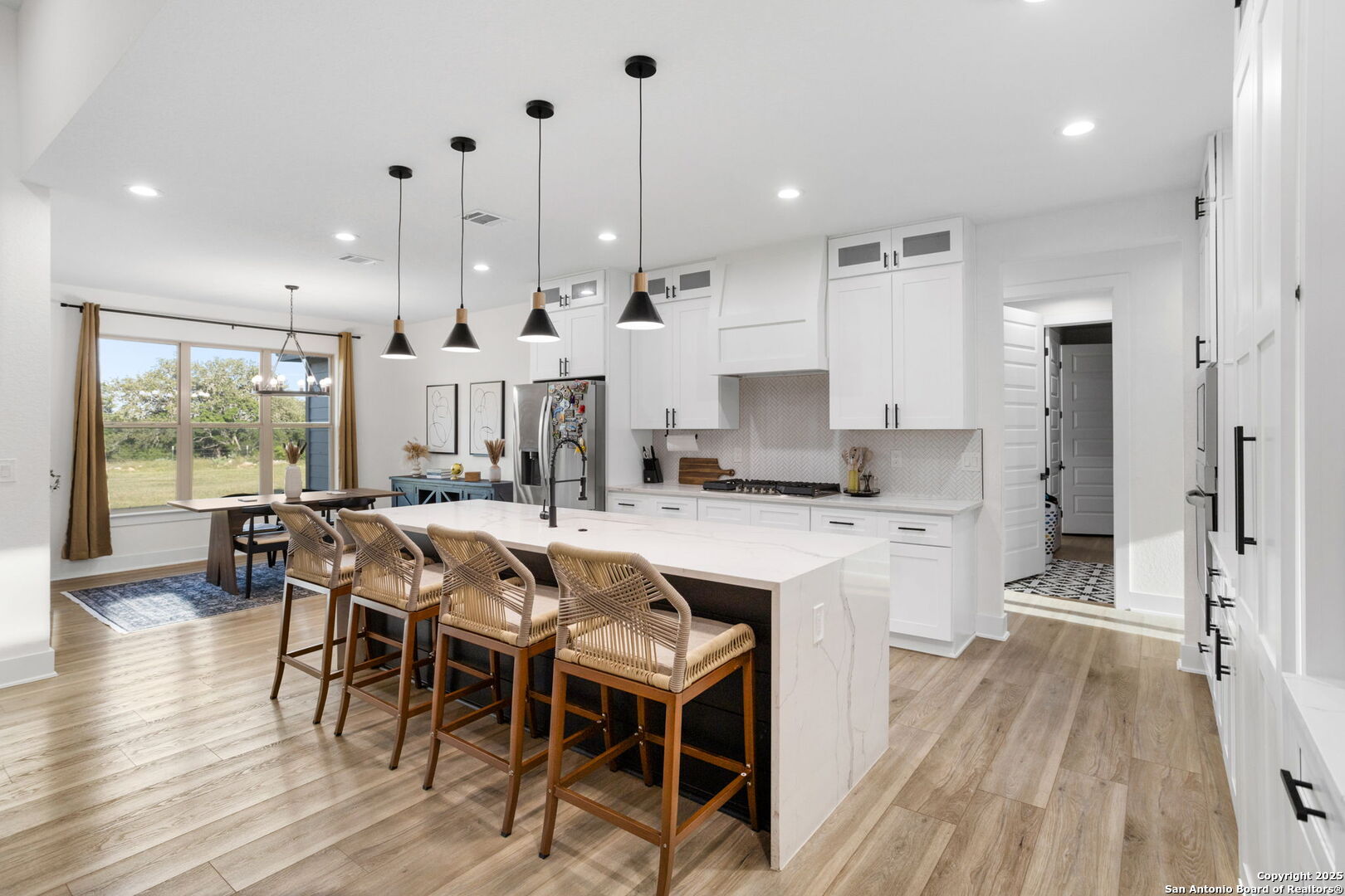 187 Stone Loop Castroville, TX 78009 - Photo 12 of 30 a large kitchen with a table and chairs