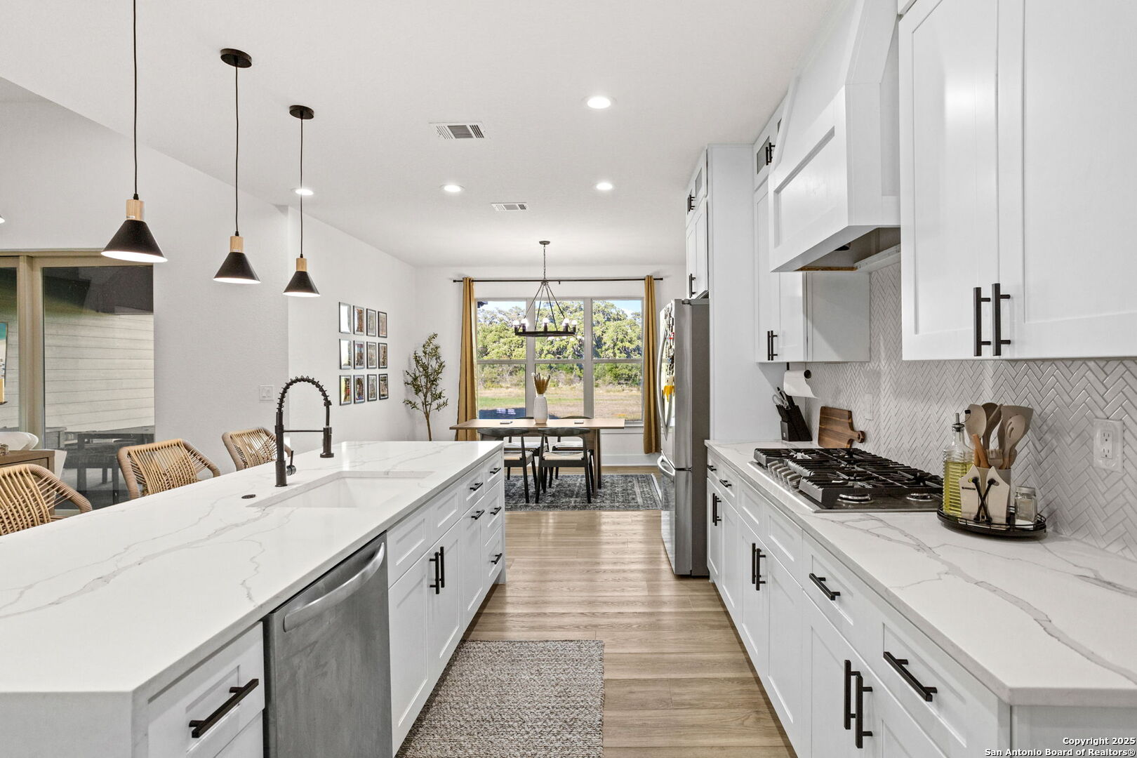 187 Stone Loop Castroville, TX 78009 - Photo 14 of 30 a large kitchen with stainless steel appliances lots of counter space sink and a window