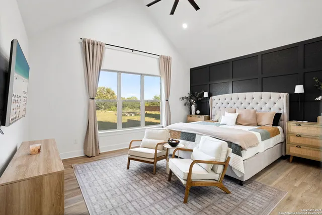 a bedroom with a bed and large window