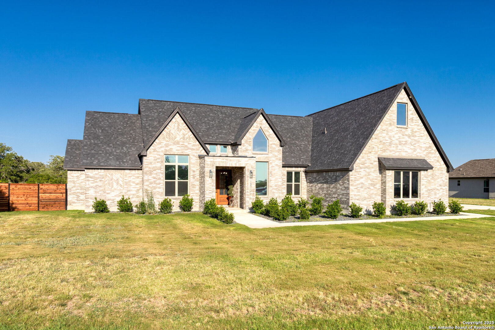 187 Stone Loop Castroville, TX 78009 - Photo 2 of 30 a front view of a house with a yard