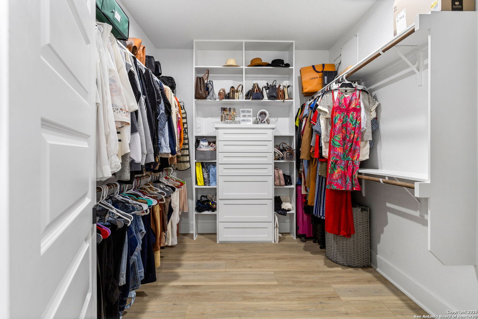 187 Stone Loop Castroville, TX 78009 - Photo 21 of 30 a view of walk in closet with clothes and shoes