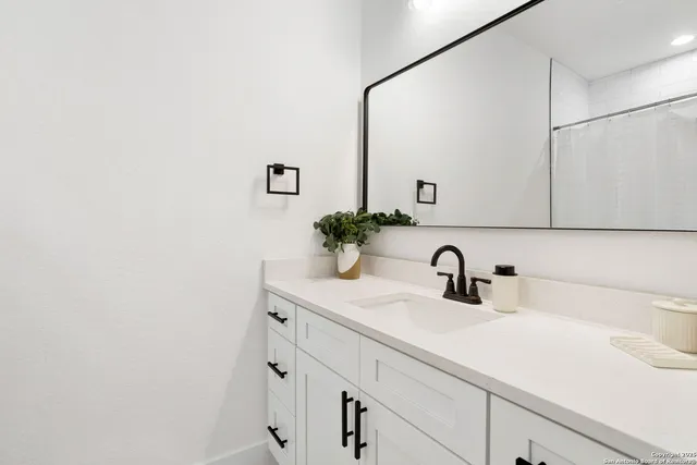 a bathroom with a sink and a mirror