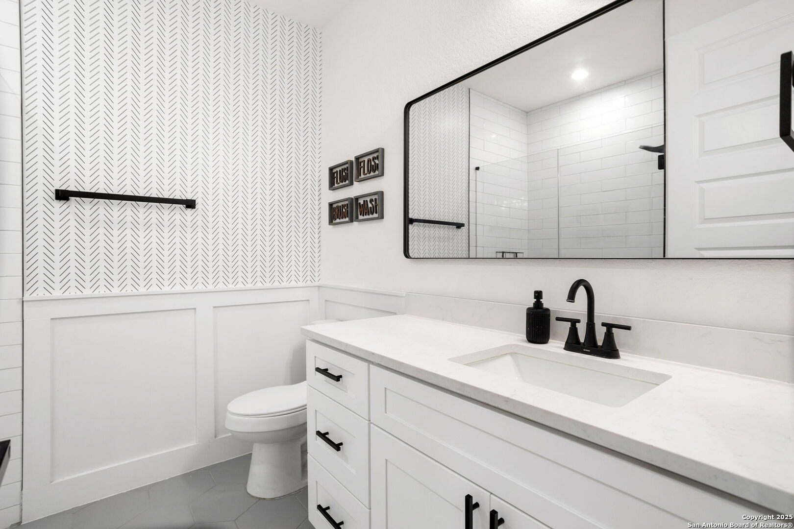 187 Stone Loop Castroville, TX 78009 - Photo 25 of 30 a bathroom with a sink a toilet and mirror