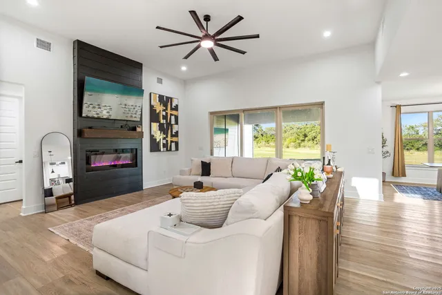 a living room with furniture fireplace and a window