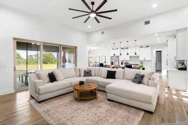a living room with furniture and a large window