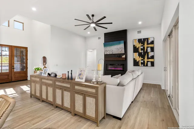 a living room with furniture and a wooden floor