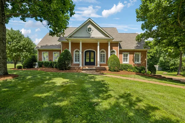 a front view of a house with a yard