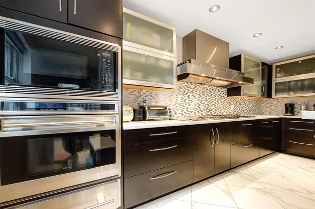 a kitchen with stainless steel appliances and cabinets