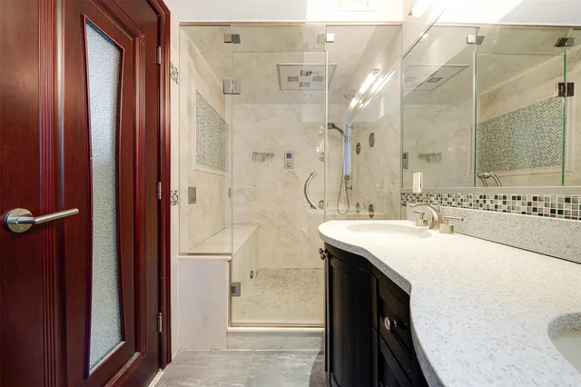 a view of an empty room with closet and a window