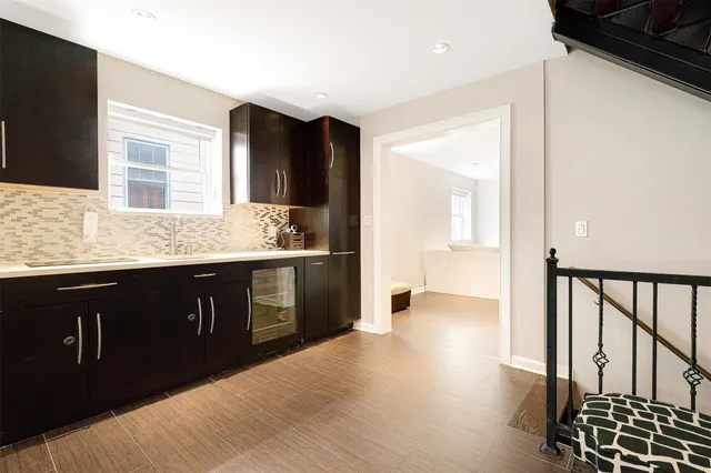 a kitchen with stainless steel appliances granite countertop a sink and wooden cabinets