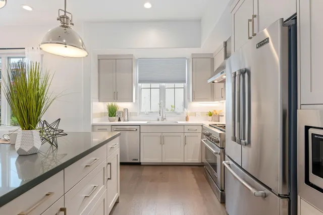 a kitchen with a refrigerator and a sink