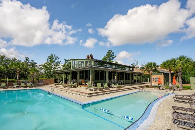 a view of swimming pool with outdoor seating