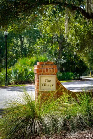 a sign board with yard in the back