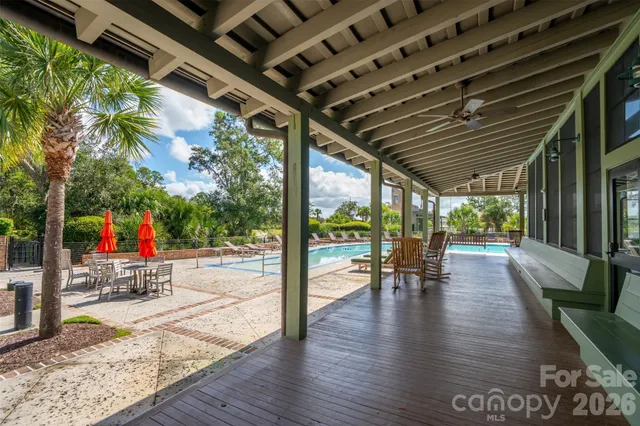 a view of a porch with wooden floors and bench