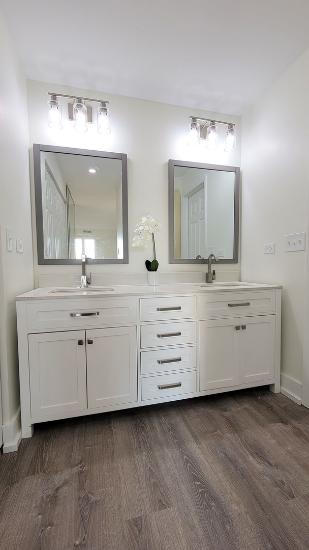 1280 Rudolph Drive, Unit 5E Northbrook, IL 60062 - Photo 12 of 33 a bathroom with a double vanity sink and a mirror