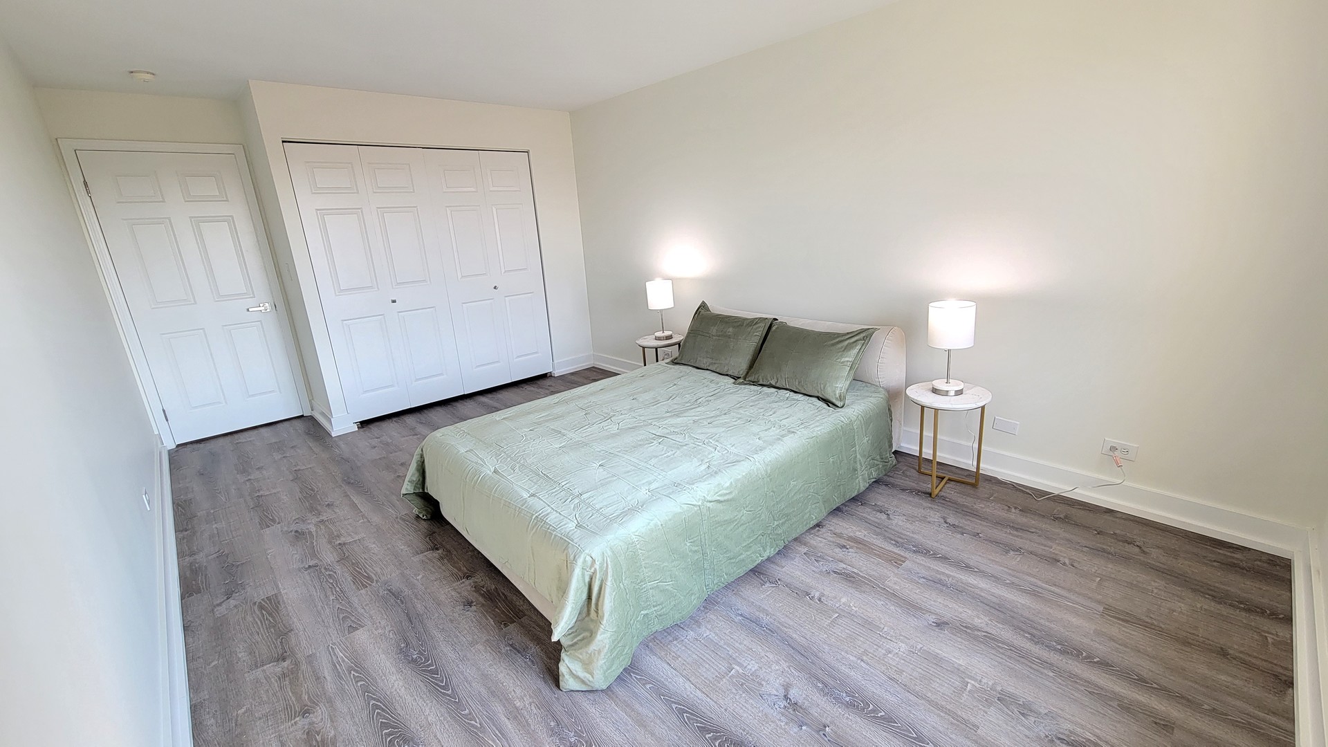 1280 Rudolph Drive, Unit 5E Northbrook, IL 60062 - Photo 16 of 33 a bedroom with a bed and wooden floor