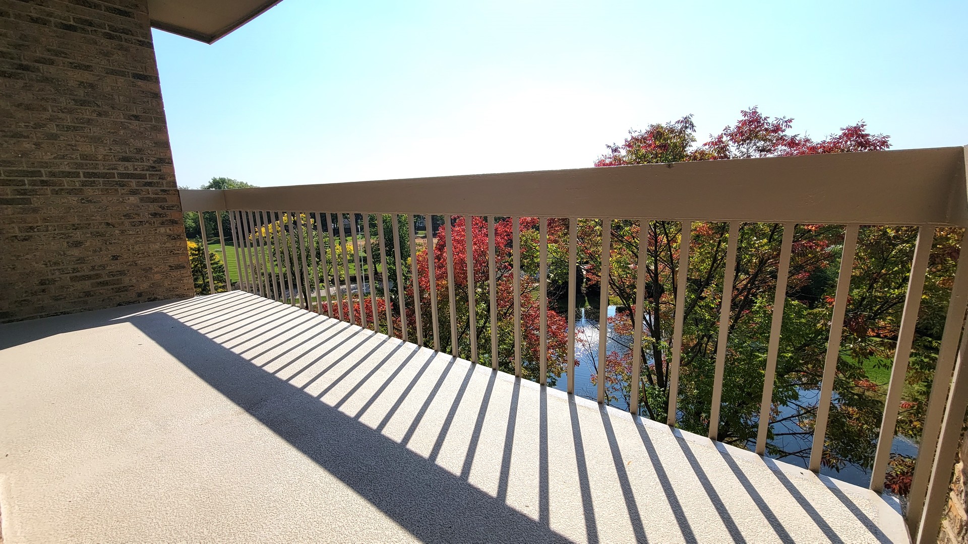 1280 Rudolph Drive, Unit 5E Northbrook, IL 60062 - Photo 20 of 33 a view of a balcony with wooden floor and fence