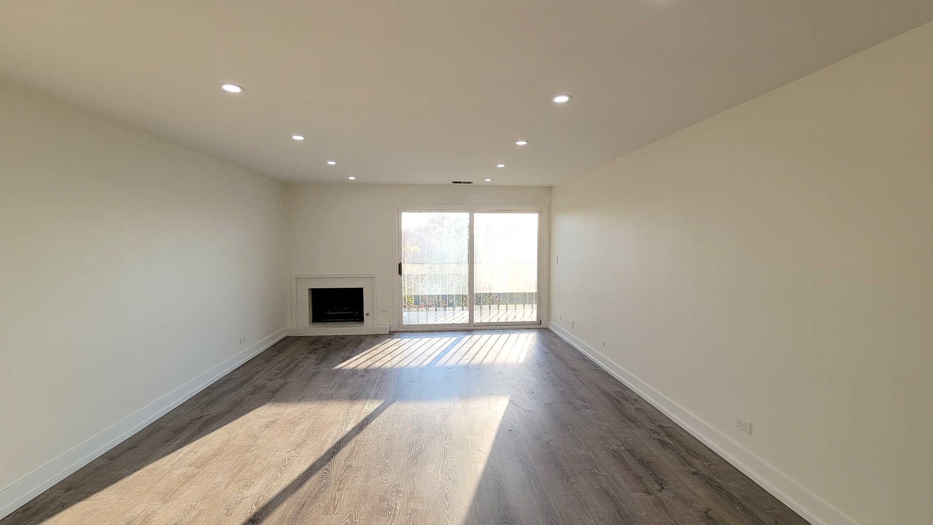 1280 Rudolph Drive, Unit 5E Northbrook, IL 60062 - Photo 4 of 33 a view of an empty room with wooden floor and a window