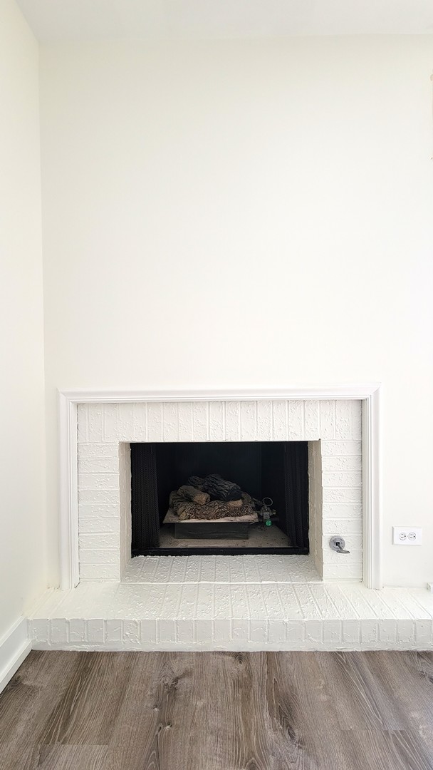 1280 Rudolph Drive, Unit 5E Northbrook, IL 60062 - Photo 5 of 33 a living room with a fireplace and a flat screen tv