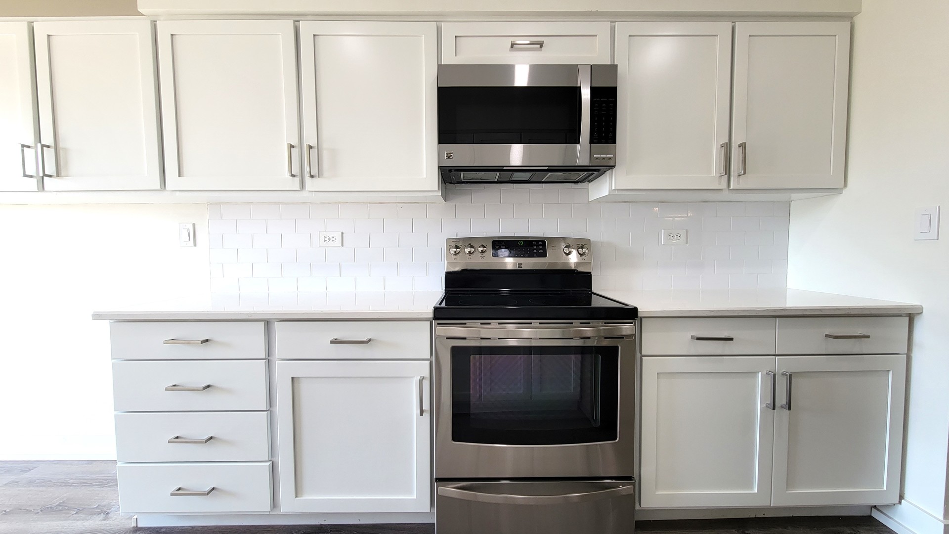 1280 Rudolph Drive, Unit 5E Northbrook, IL 60062 - Photo 7 of 33 a kitchen with white cabinets stainless steel appliances and sink