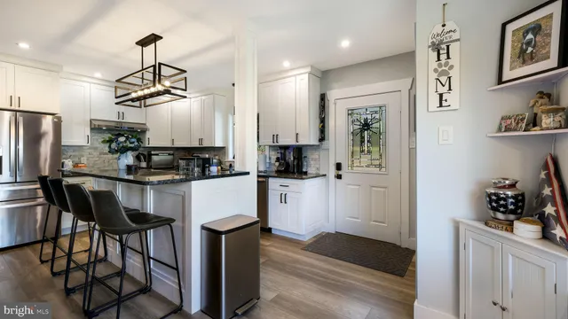 a kitchen with stainless steel appliances a refrigerator and microwave