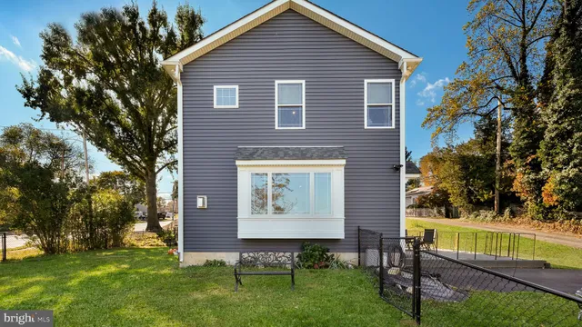 a view of a house with backyard porch and sitting area