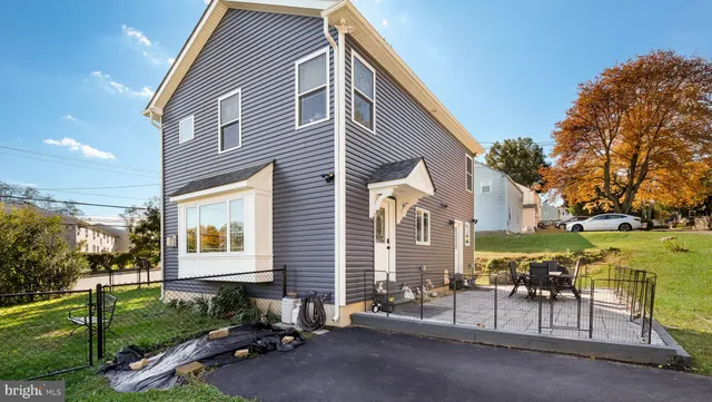 a view of a patio with table and chairs and potted plants