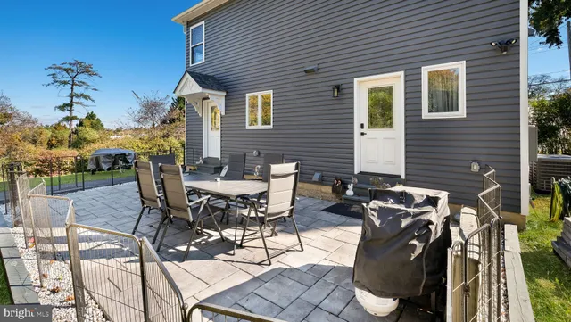 a view of a patio with table and chairs with wooden floor and fence