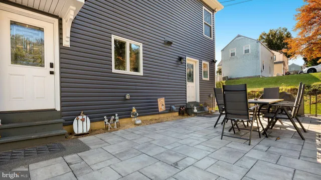 a front view of a house with swimming pool having outdoor seating