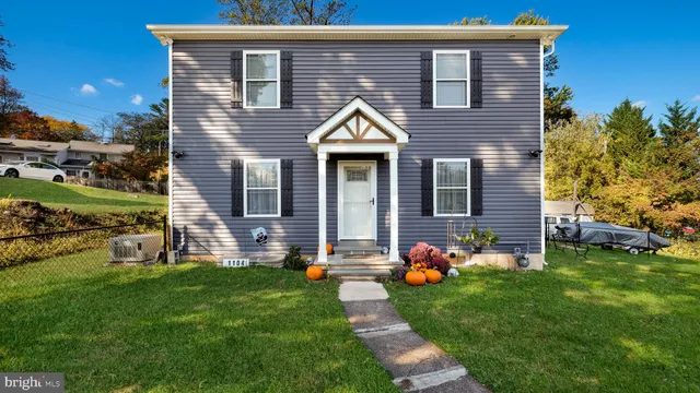 a front view of house with yard and outdoor seating