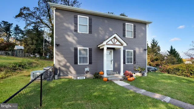 a front view of house with yard and outdoor seating