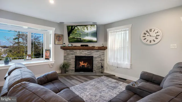 a living room with furniture a window and a fireplace