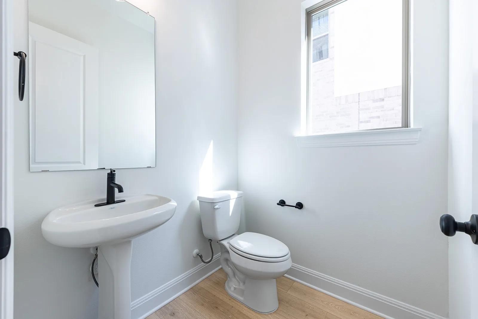 308 Buckaroo Drive Georgetown, TX 78633 - Photo 23 of 31 a bathroom with a toilet sink and mirror