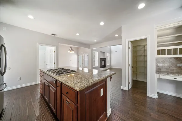 a kitchen with a stove and a refrigerator