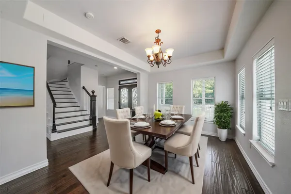 a view of a dining room with furniture wooden floor and chandelier