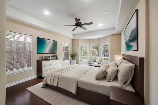a bedroom with bed tv and window