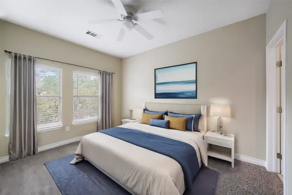 a bedroom with a large bed and a window