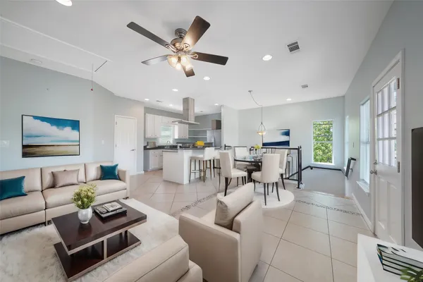 a living room with furniture and view of kitchen